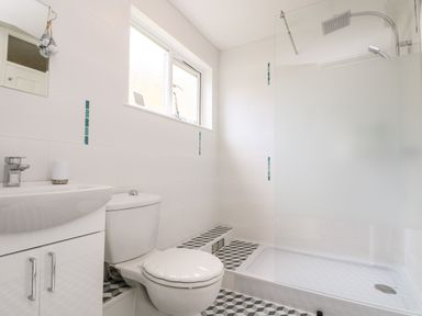 A bathroom with a toilet sink and shower at Valley Lodge 52 in Callington