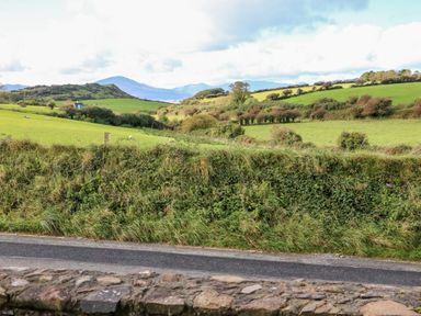A rural landscape with green fields bushes hills and a road at The Blue Annex in The Spa near Tralee County Kerry