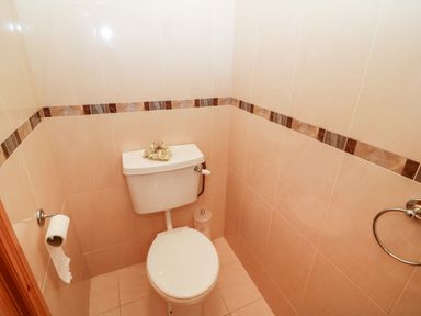 A small bathroom with a toilet and tiled walls at The Blue Annex in The Spa near Tralee County Kerry