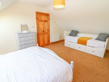 A bedroom with a bed dresser and daybed at The Blue Annex The Spa near Tralee County Kerry