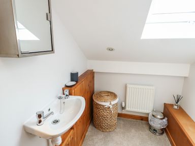 A bathroom with sink and mirror at Yr Orsedd in Llanfaethlu