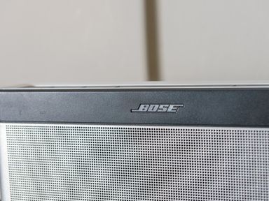 A close-up of a Bose speaker grill with the Bose logo