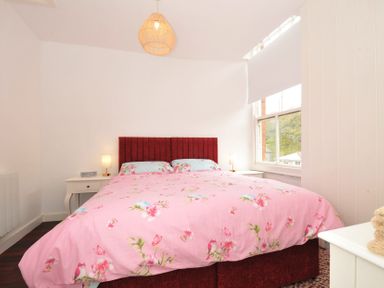 A bedroom with a bed and bedside table at Stargazy in Trebarwith Strand near Tintagel