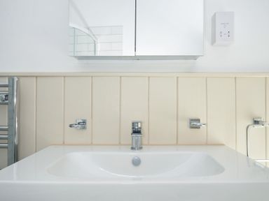 A bathroom with a sink and mirror at Stargazy in Trebarwith Strand near Tintagel