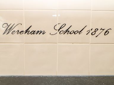 Wall tiles with the text Wereham School 1876 written on them at The Old School in Downham Market