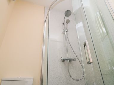 A bathroom with a glass shower enclosure and a toilet at Ryedale Country Lodges - Hazel Lodge in Kirkbymoorside