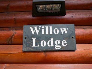 A sign that reads Willow Lodge at Ryedale Country Lodges - Willow Lodge Kirkbymoorside