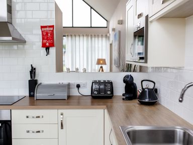 A kitchen with appliances on the countertop at Cowslip in Bamburgh