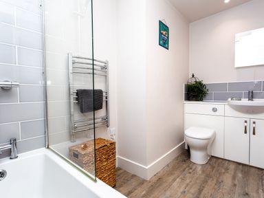 A bathroom with a bathtub and shower at Cowslip in Bamburgh