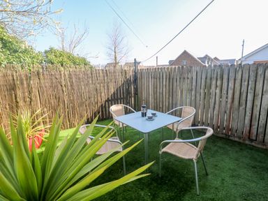 A garden with a table and chairs at Sunflower Cottage in St Issey