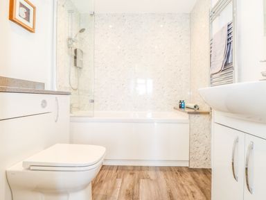 A bathroom with a toilet sink bathtub and shower at The Crest in Helston