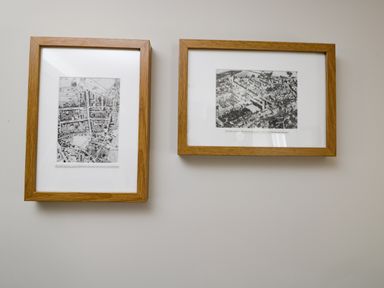 Two framed black and white aerial photo maps on a white wall at Troopers Cottage in Frome