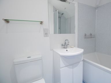 A bathroom with a toilet sink bathtub and shower at Thorncroft in West Bay
