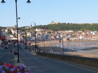A view of the coastline with buildings and beach at Cayton Pines in Cayton Bay near Scarborough