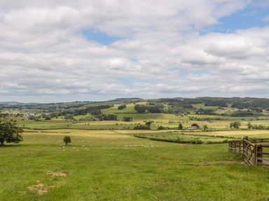 A rural landscape with green fields sheep trees and hills at The Steadings in Rothbury