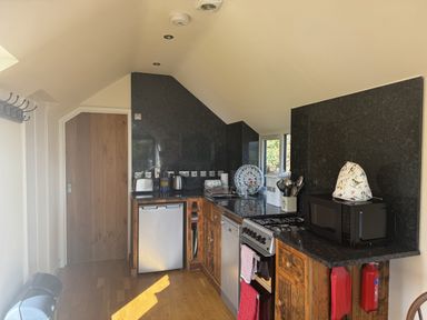 A kitchen with appliances and cabinets at The Hideout in Llangrove
