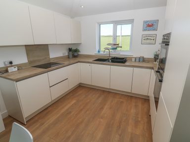 A kitchen with sink and countertop at Sandpiper in Perranporth