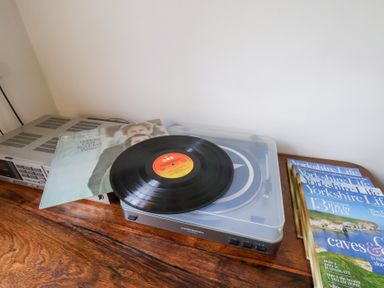 A record player with a vinyl record and magazines at 20A St Hilda's in Whitby