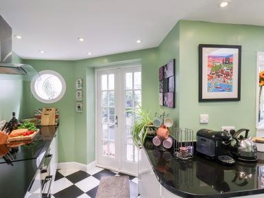 A kitchen with a countertop and a door leading outside at 20A St Hilda's in Whitby