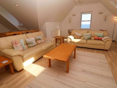 A living room with two sofas and a table at Meridian in Carbis Bay