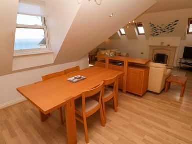 A living room with dining furniture and window in Meridian, Carbis Bay