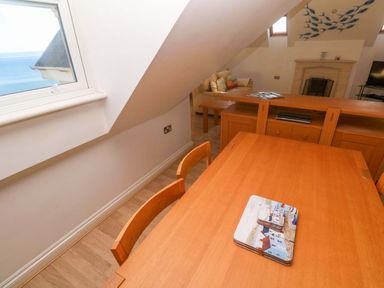 A living room with a table and chairs at Meridian in Carbis Bay