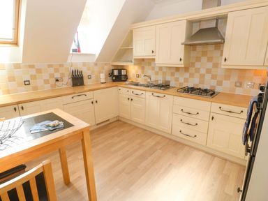 A kitchen with cabinets, a sink, and a stove at Meridian in Carbis Bay