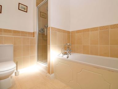 A bathroom with a shower, toilet, and bathtub at Meridian in Carbis Bay