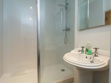 A bathroom with a shower and sink at Damson Cottage Whitby