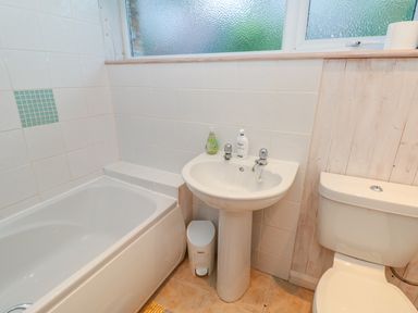 A bathroom with a bathtub sink and toilet at Estuary View House and Annexe in Dartmouth