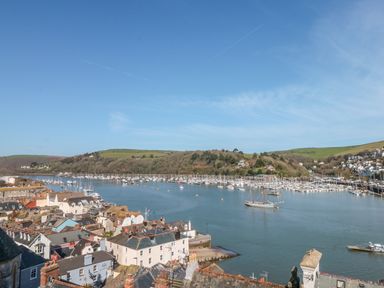A view of a river with boats and houses along the shore at Estuary View House and Annexe in Dartmouth