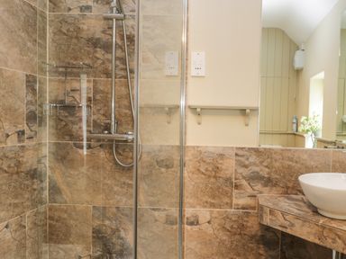 A bathroom with a glass enclosed shower and a countertop basin at Stakesby House Apartment 3 in Whitby