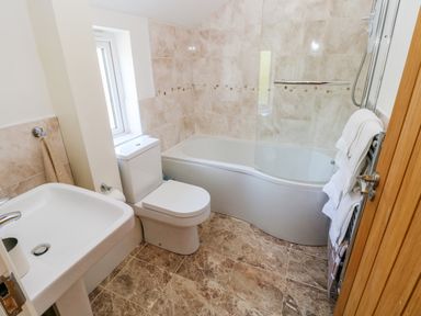 A bathroom with a sink toilet bathtub shower and towels at Little Freestone in Carew
