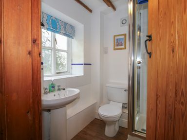 A bathroom with a window sink toilet and shower at Hunters Moon in Tenbury Wells