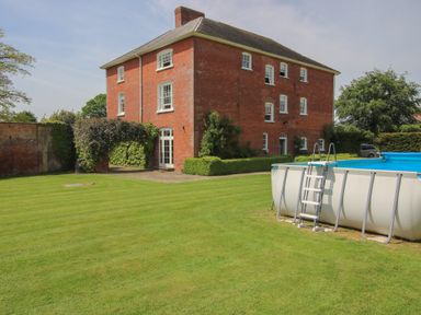 A house with a pool and lawn at Hilltop House in Tenbury Wells