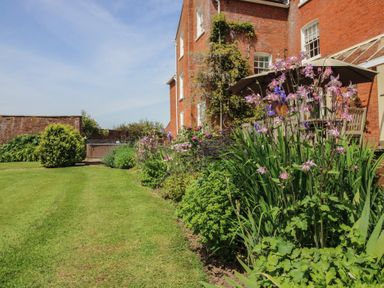 Garden with flowers and grass at Hilltop House in Tenbury Wells