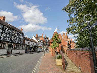 A street view with buildings and a signpost at The Chestnuts Tenbury Wells