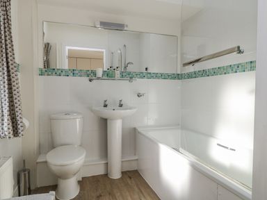 A bathroom with a toilet, sink, and bathtub at Keepers Cottage in West Knoyle