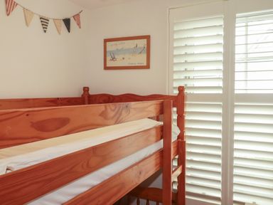 A bunk bed with decorative items at Beachcomber in Padstow