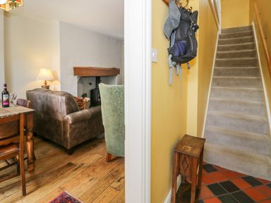 A living room with a sofa and table near stairs at Sygun View in Beddgelert