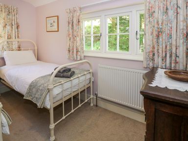 A bedroom with a bed and a table at Sygun View in Beddgelert