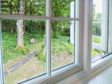 A view from a window showing a garden with a bench at Sygun View in Beddgelert
