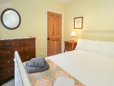 A bedroom with a bed and dresser at Sygun View in Beddgelert