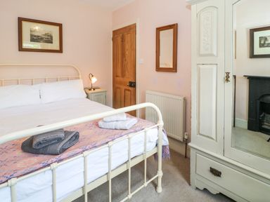 A bedroom with a bed and wardrobe at Sygun View in Beddgelert