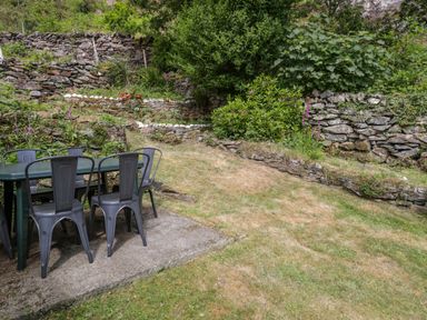 A table and chairs in a garden at Sygun View Beddgelert