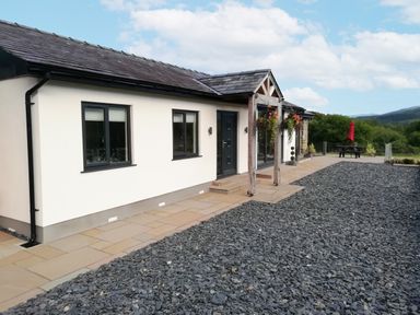 An outdoor view of a house with a pathway at Cartref in Trawsfynydd