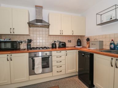 A kitchen with stove oven microwave toaster kettle dishwasher and bread box at The Linhay in Chardstock