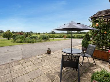 An outdoor area with a table and chairs at Willow Barn in Cucklington near Wincanton