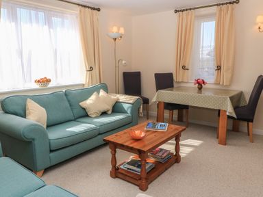 A living room with a sofa and table at Willow Barn in Cucklington near Wincanton
