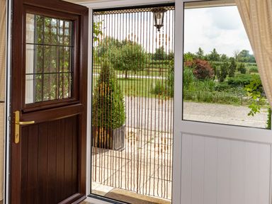 An entrance area with a door and a view of the garden at Little Barn in Cucklington near Wincanton